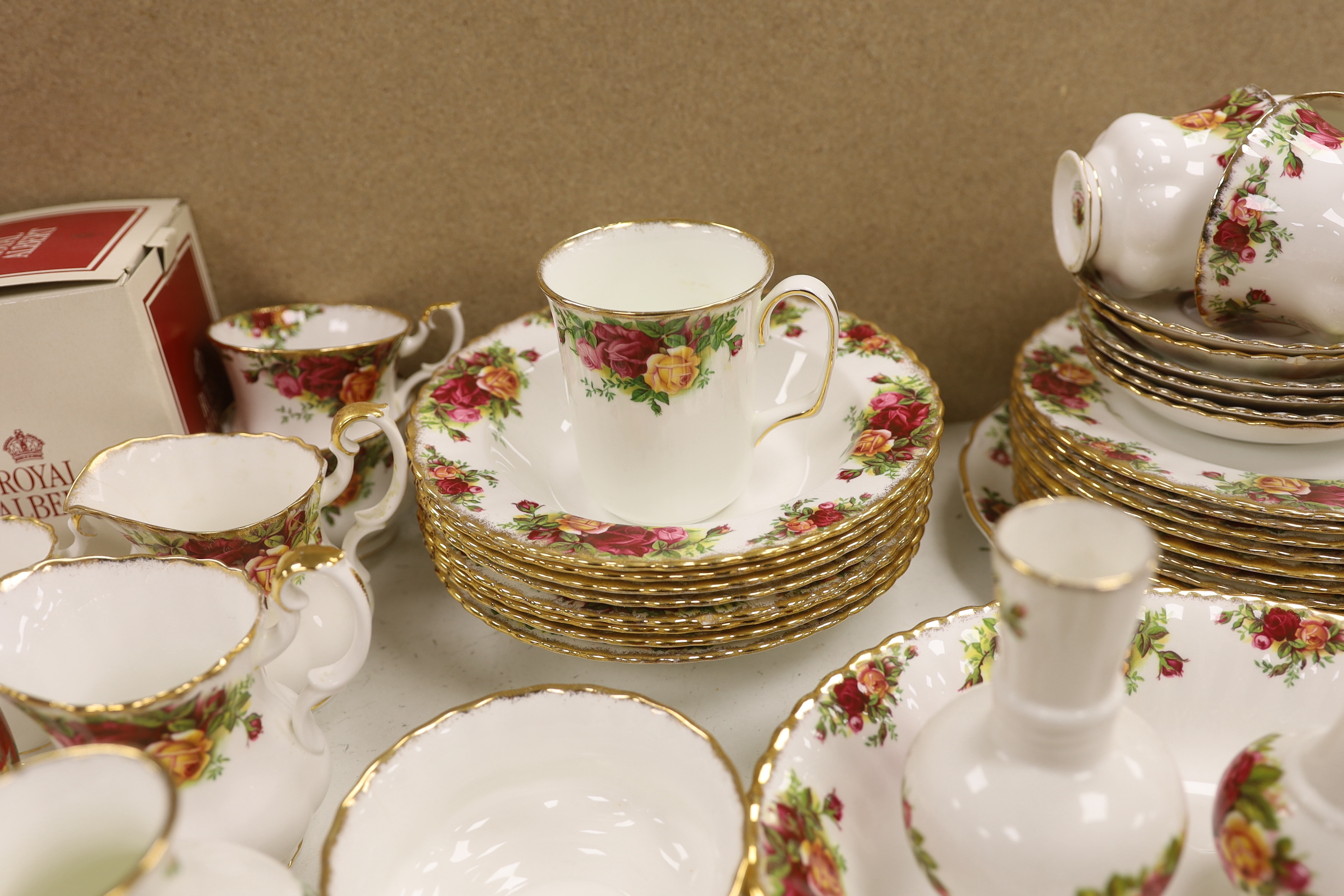 A Royal Albert Old Crown Roses dinner and tea service and a Doulton Lambeth vase